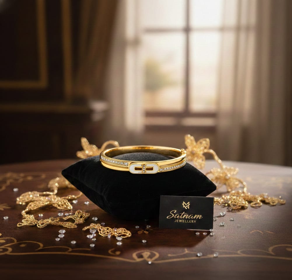 Gold-plated bracelet with imitation diamonds displayed on a black velvet cushion.