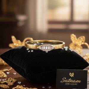 Gold-plated bracelet with butterfly accents and imitation diamonds on velvet cushion.